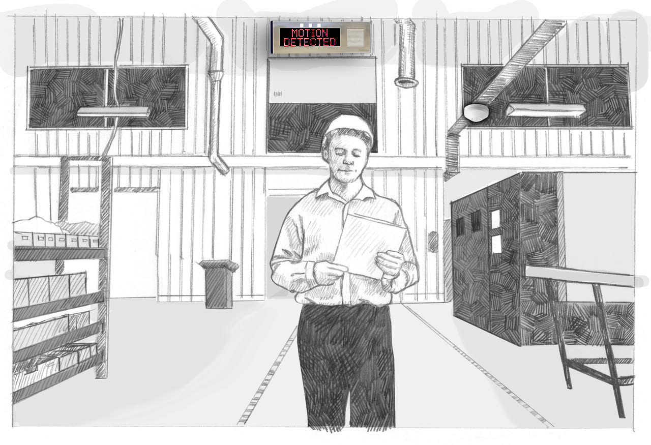 A worker in a hard hat walks through a warehouse. On the wall, the large Outdoor IP Sign shows the time and date.