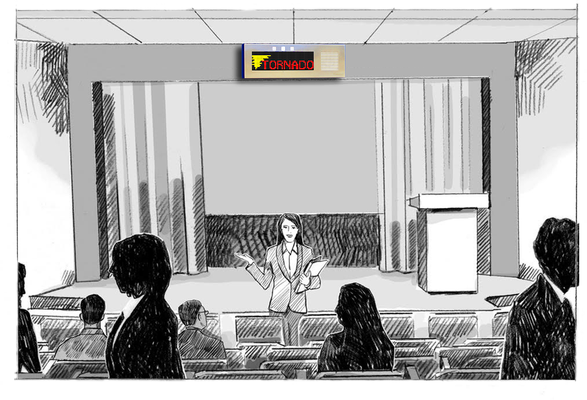 A presenter in a lecture hall with a a Large IP Signboard on the wall warning of a tornado.