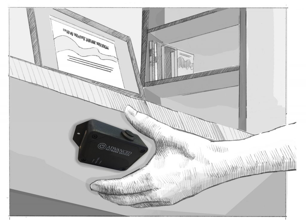 A hand presses a Smart IP Button under an office desk.